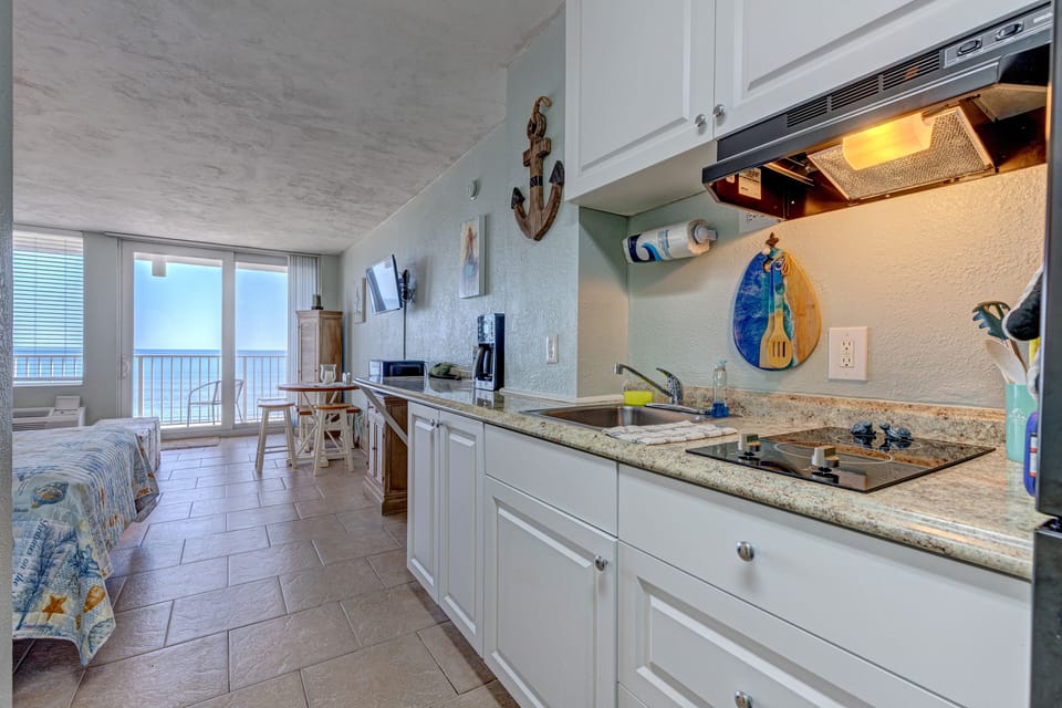 Bright beachside kitchenette with ocean views, stocked essentials, and charming coastal décor—perfect for easy meals during your seaside stay.