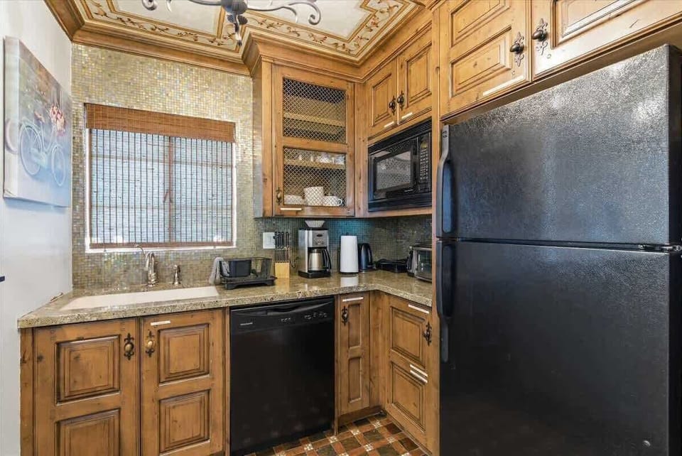 Unit 1: Inviting kitchen with modern appliances and bar seating for 2 guests.