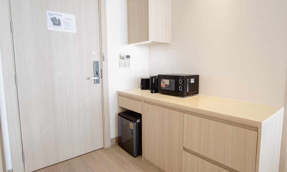 Coffee station with kettle and storage cabinets for added guest convenience.
