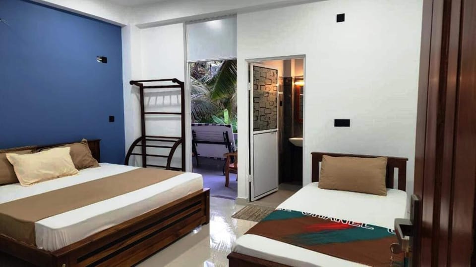 Family Triple Room, Garden View | In-room safe, desk, laptop workspace, blackout drapes