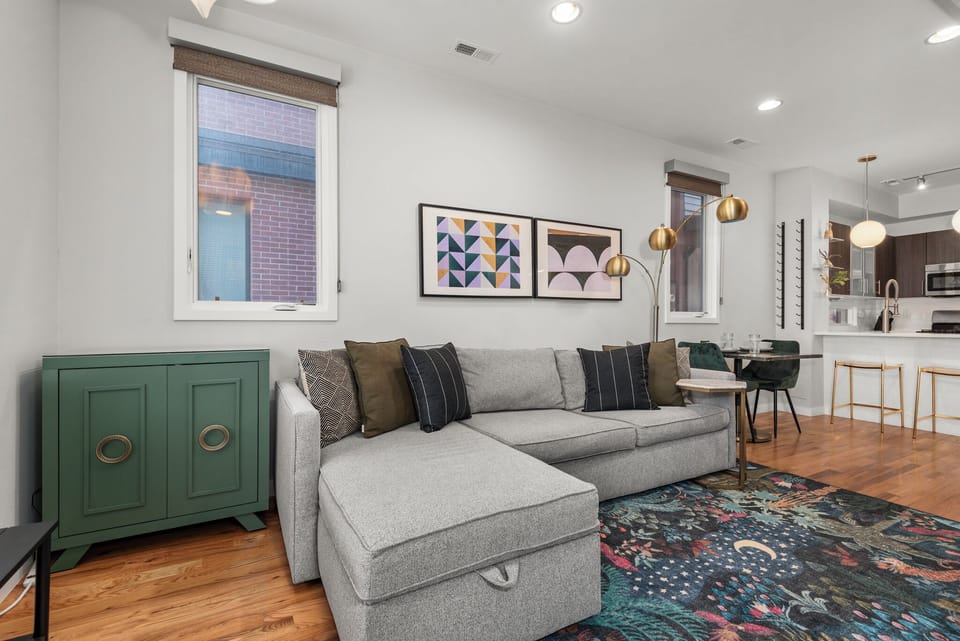 Sunlit living space blending comfort, clean lines, and a welcoming city-home feel