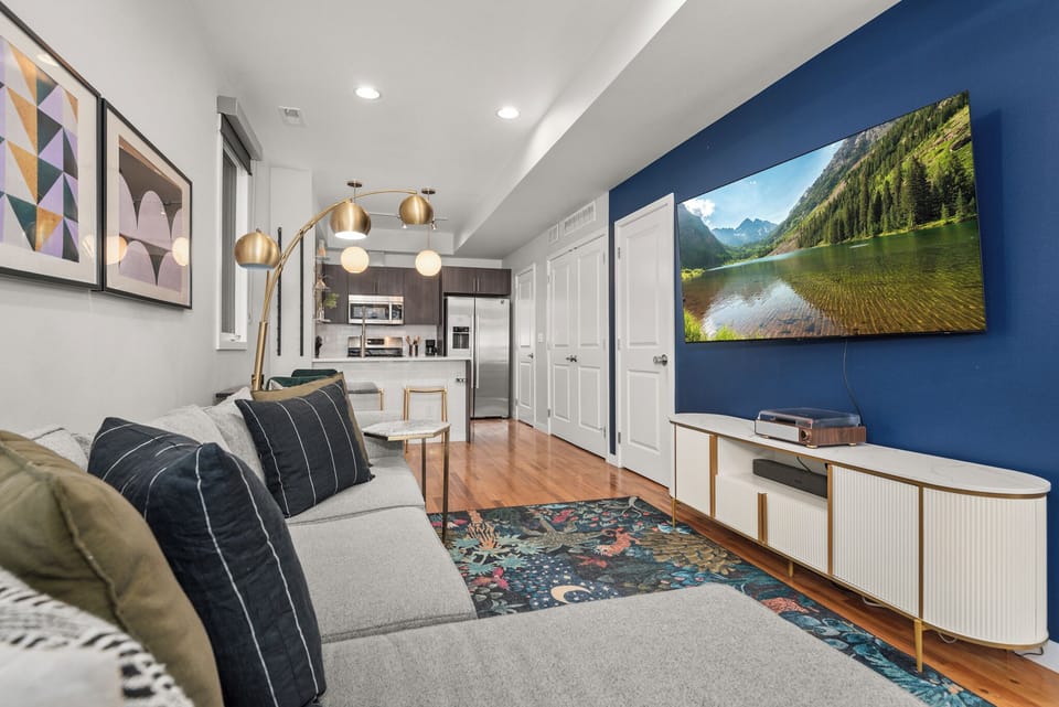 Bright open living area with smart TV, comfortable seating, and seamless dining flow