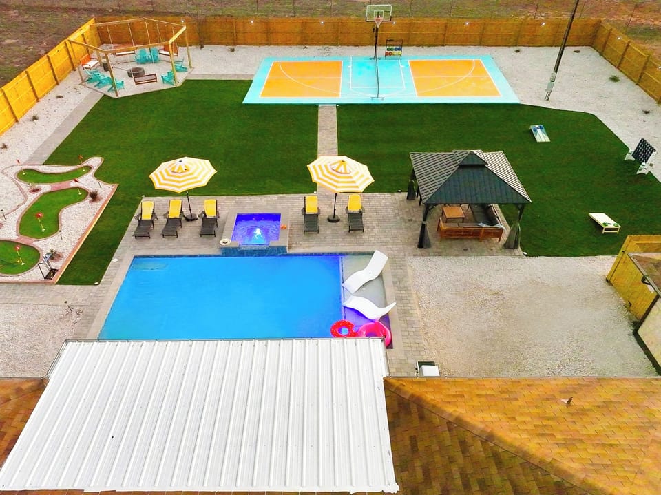 This backyard has it all!  Play on the pickleball court, relax in the spa pool, putt on the 6-hole mini golf course, and gather around the 16-seater fire pit. Final touches are in progress—professional photos coming soon!