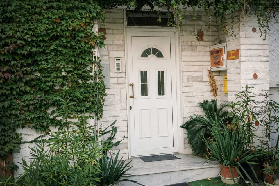 Charming entrance framed by greenery, welcoming guests into a calm and comfortable stay close to Alexandroupolis town center