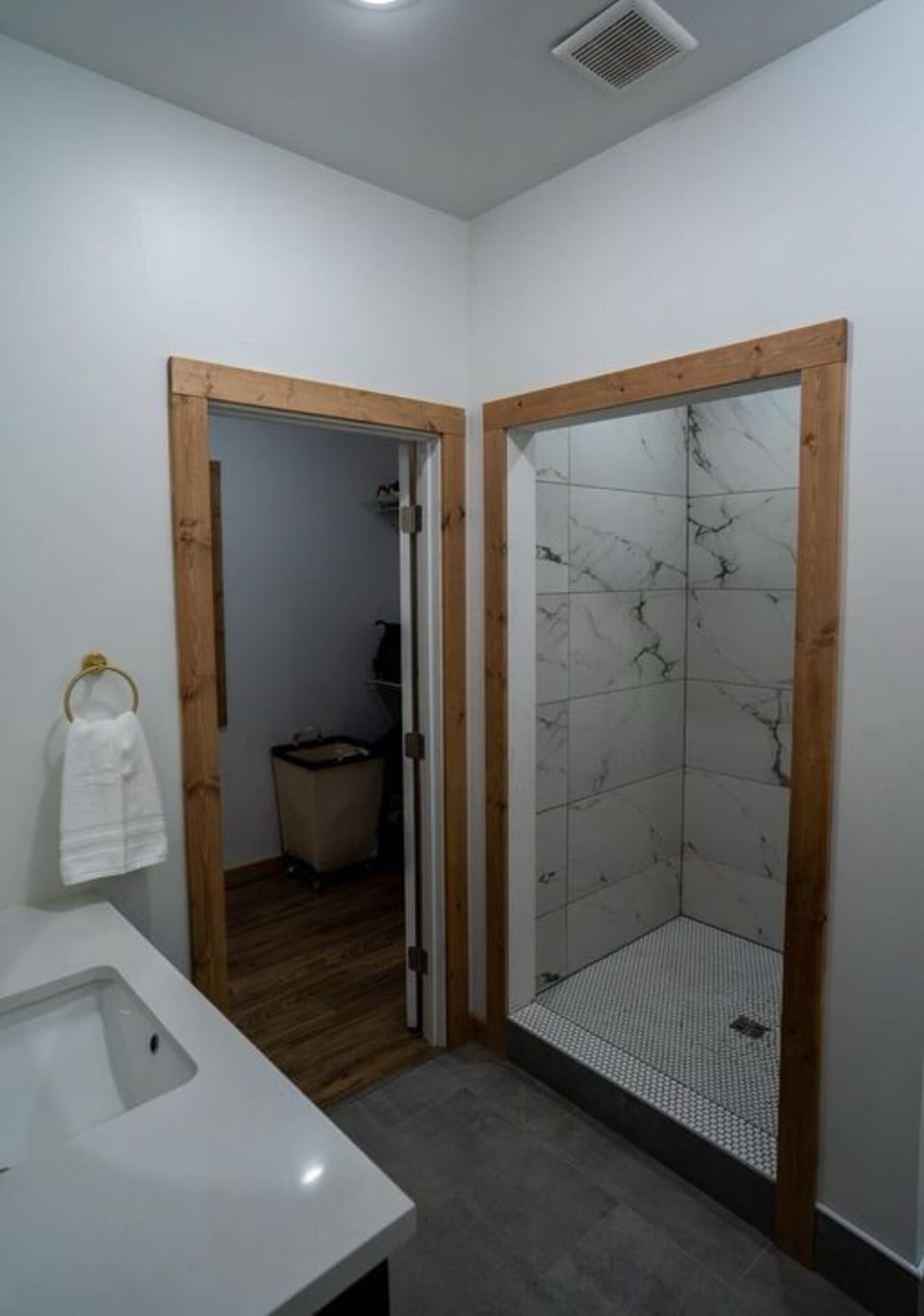 Primary bathroom with a shower and a walk in closet