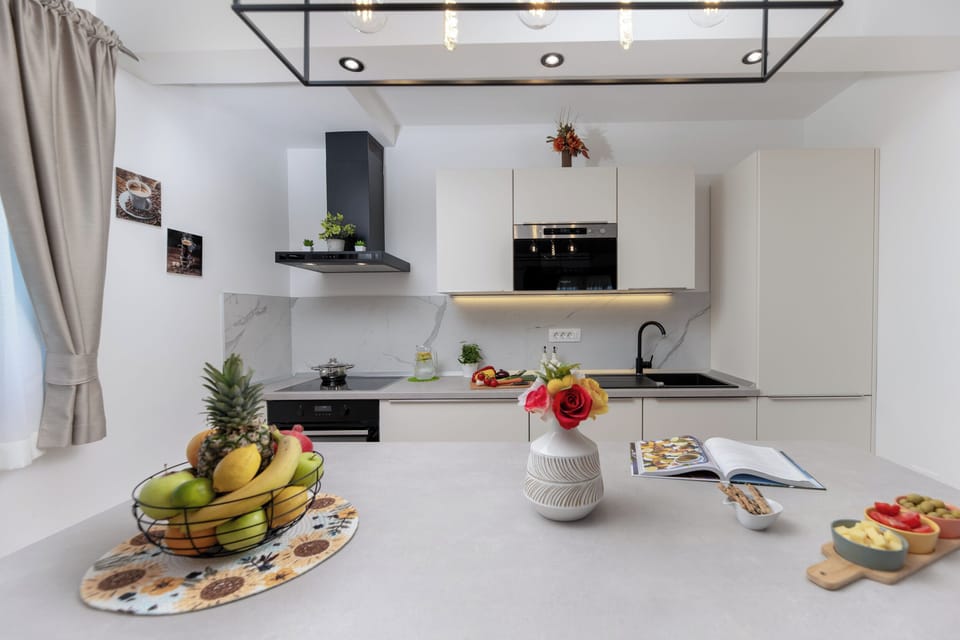 "Modern kitchen with fresh fruit and a bright, welcoming setup."