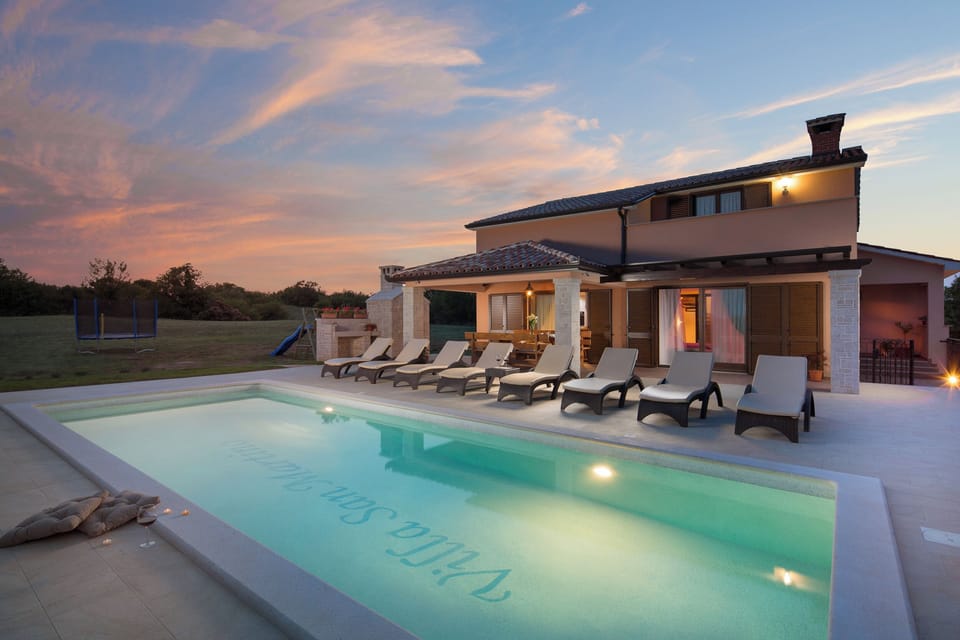 "Private heated pool with beautiful evening lighting".