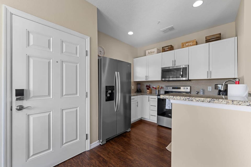Modern kitchen with stainless steel appliances and granite countertops