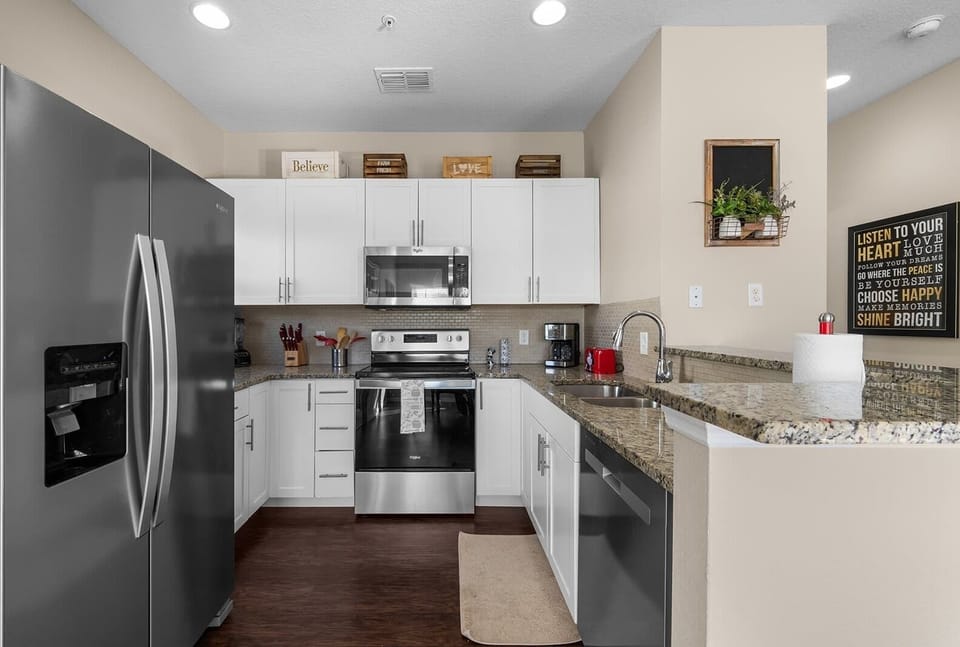 Modern kitchen with stainless steel appliances and granite countertops