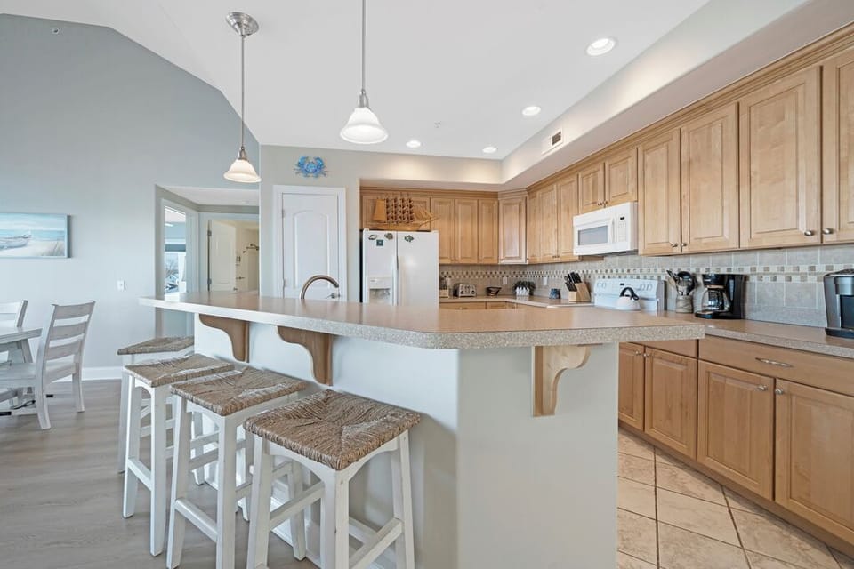The Living Area opens up to the Chef's Kitchen, with all the comforts of home.