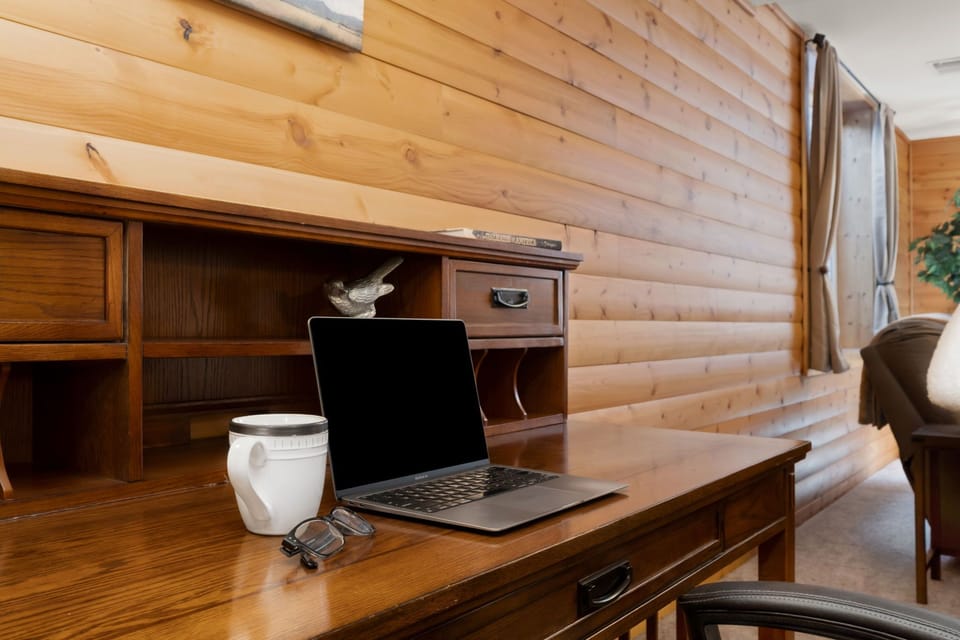 Your dedicated workspace features warm wood furnishings and natural light—perfect for catching up on emails or planning adventures.