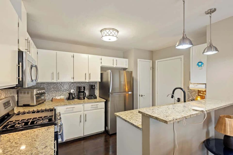 A kitchen ready for cooking full meals, equipped with a variety of quality cookware and cooking essentials.