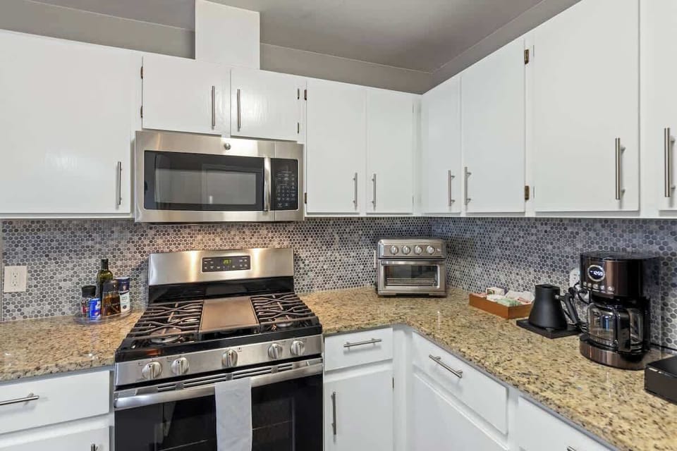 Coffee bar with an electric kettle, tea, hot chocolate, and multiple coffee options (drip, Keurig, instant).