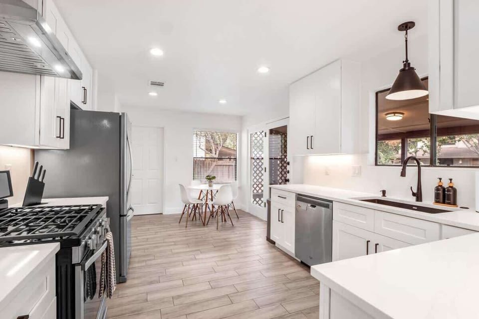 Modern full kitchen with stainless steel appliances, gas stove, dishwasher, and plenty of counter space. Fully stocked with cookware, dishes, and essentials, it’s perfect for preparing family meals or enjoying a morning coffee before exploring Austin