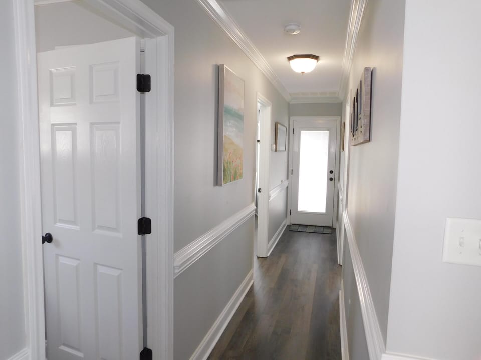 Upstairs hall from stairs. Deck access door at end of hall