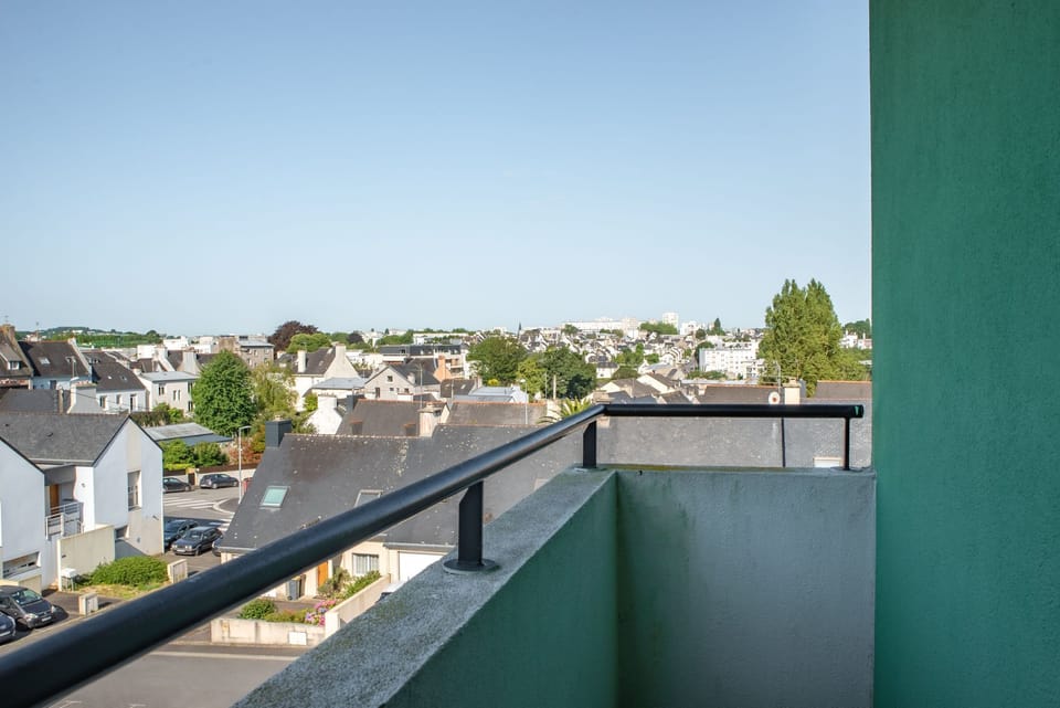 The private balcony provides an open view over the surrounding neighborhood.