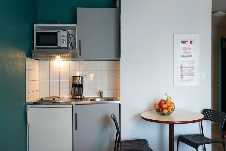 The compact kitchenette provides a convenient setup for preparing simple meals.