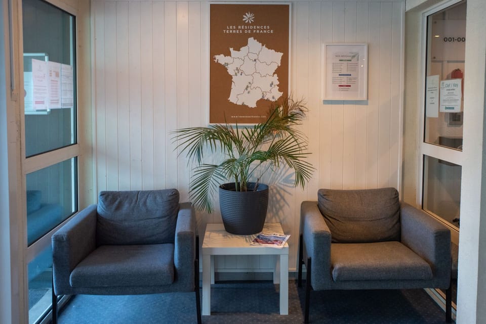 A reception space with seating and information displays, designed to welcome guests on arrival.