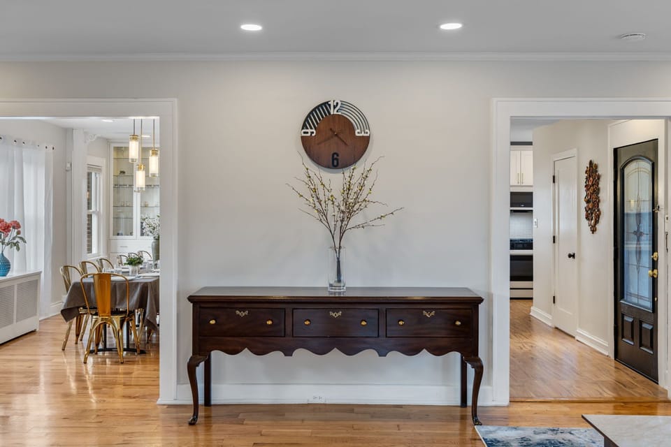 Elegant console table with minimalist styling. Transitional space connecting living areas. Functional and visually polished.
