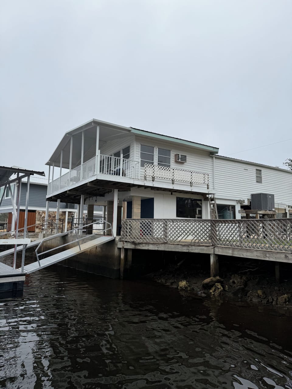 Canal view of Shellfish House with screened porch and private dock.