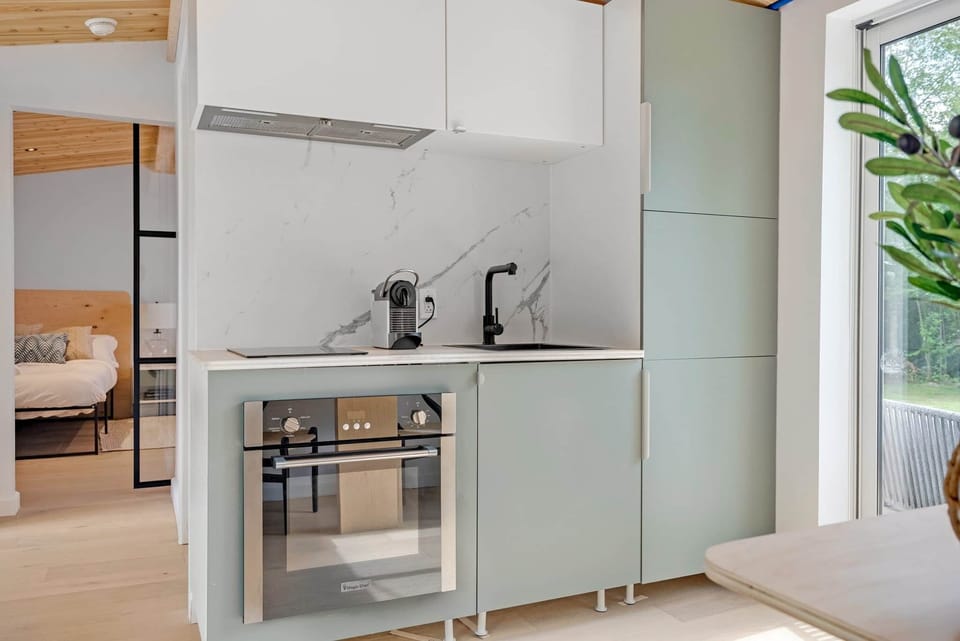 Sleek, fully equipped kitchenette with minimalist design and high-end appliances