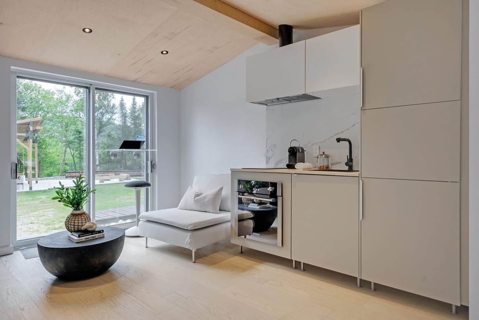 Modern, fully equipped kitchenette and bright lounge area with high-end finishes