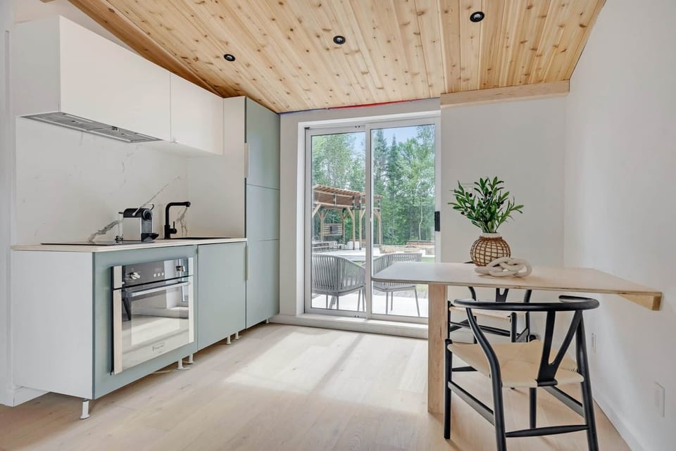Modern, fully equipped kitchenette and bright lounge area with high-end finishes