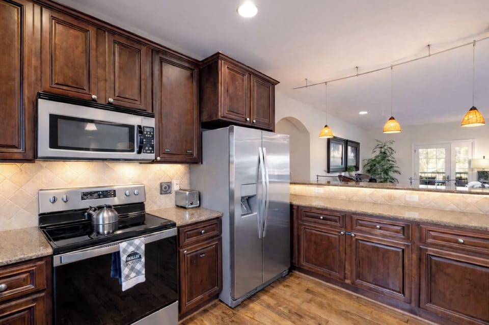 Open bar seating area off the kitchen with modern appliances. 