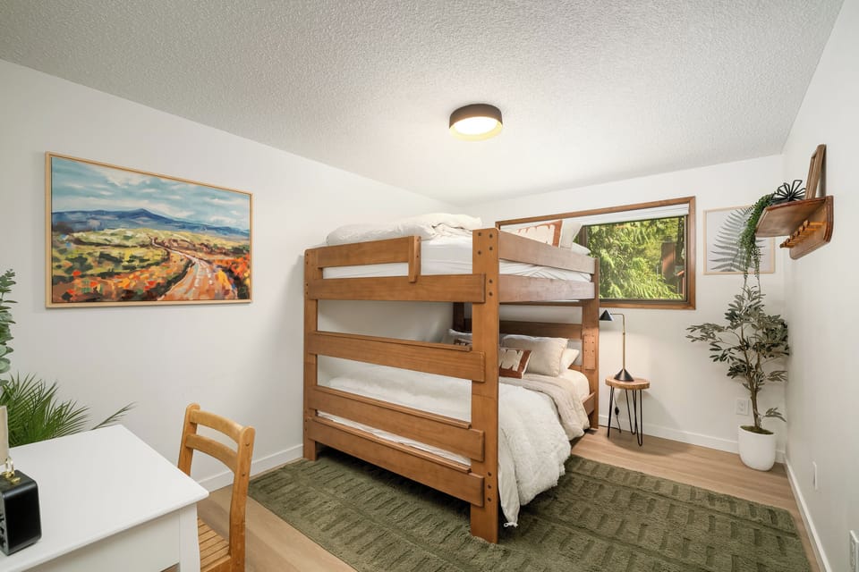 Double the sleeping space with a queen-over-queen bunk bed and a convenient desk for work or play.