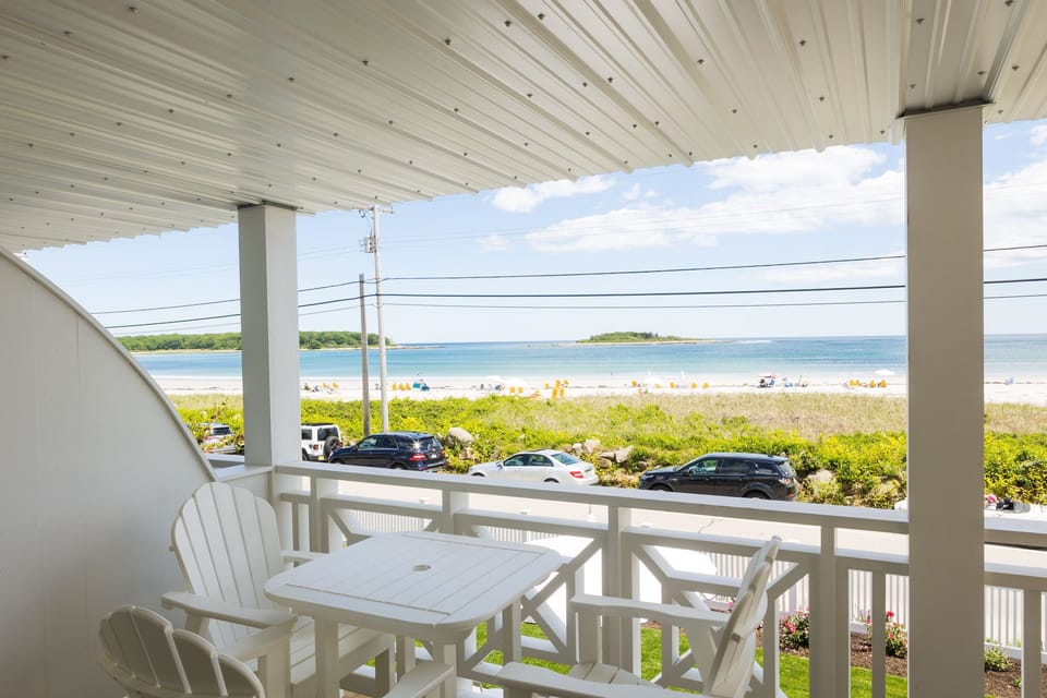 Enjoy stunning beach views from the private balcony, complete with outdoor seating and direct access to the sandy shores of Goose Rocks Beach.
