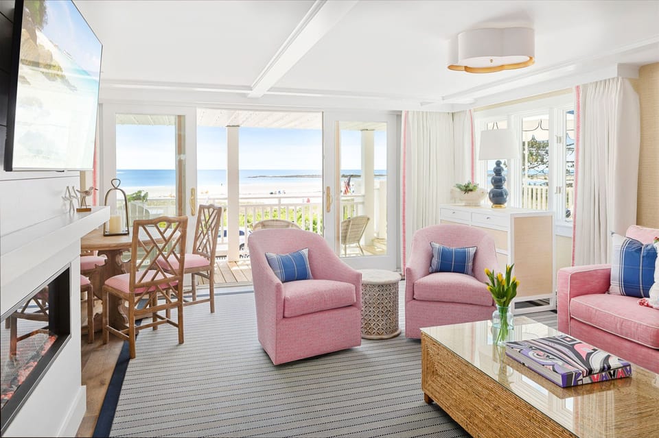 This charming living room blends comfort with coastal elegance, showcasing beautiful decor and direct access to the scenic beach from the patio.