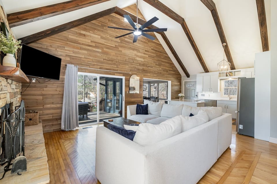 Living area with large, comfy sectional sofa, with sliders to deck.