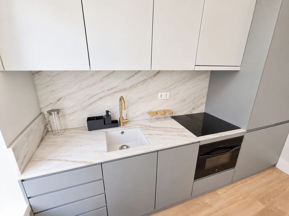 Convenient concealed washer-dryer integrated into the kitchen cabinetry.
