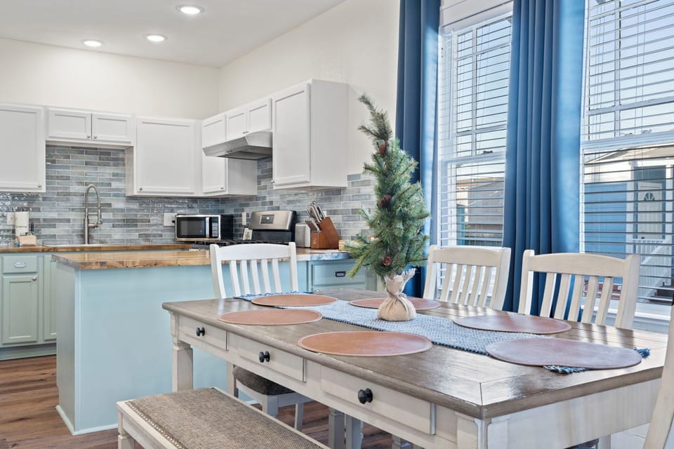 Bright dining room beside the kitchen—gather for meals, game nights, and easy conversation in a sunlit space.