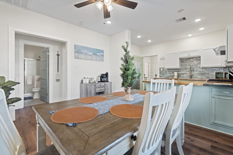 Spacious dining table in an open, airy layout—steps from the kitchen and coffee bar for easy mornings and shared meals.