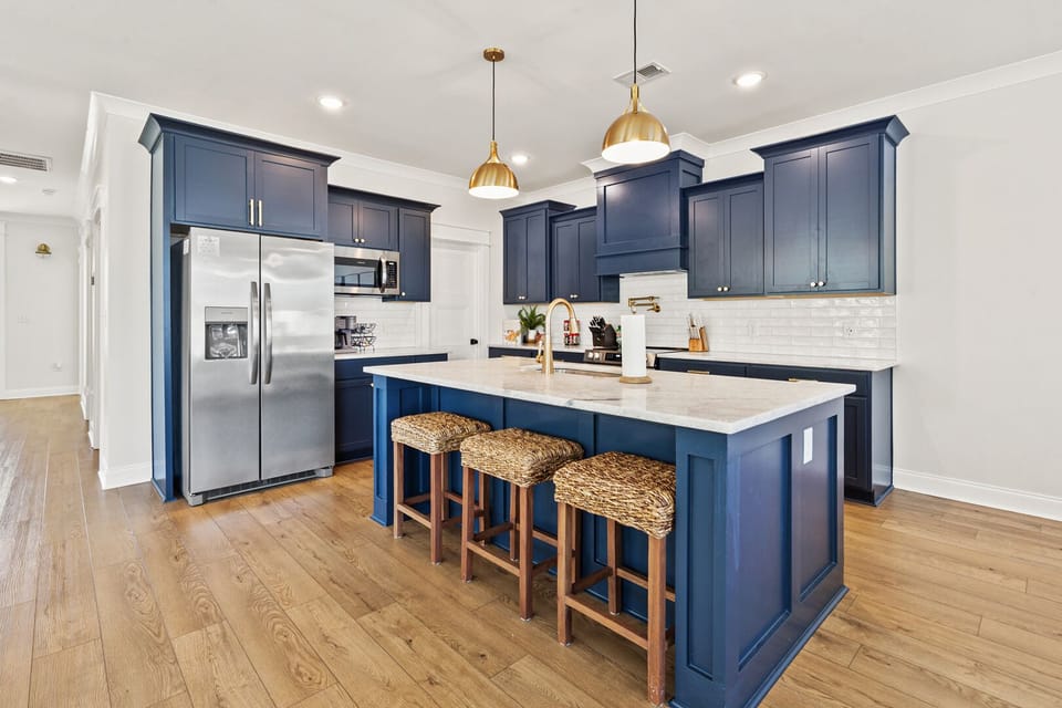 Blue cabinetry and an island with bar stools at Lost Shaker of Salt in Cherry Grove, North Myrtle Beach