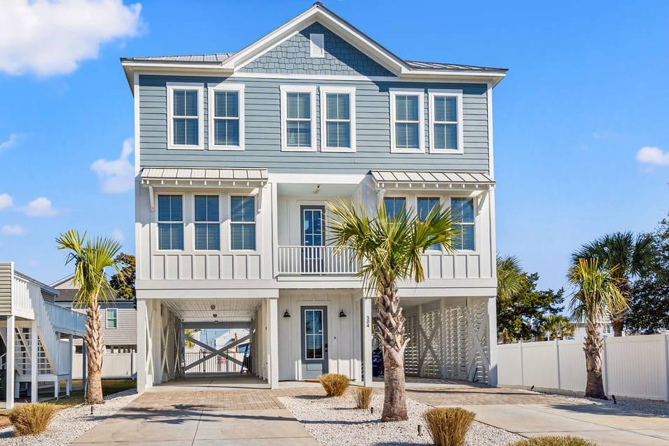 Blue-sided beach house with a covered porch at Lost Shaker of Salt, a 5-bedroom Cherry Grove vacation rental