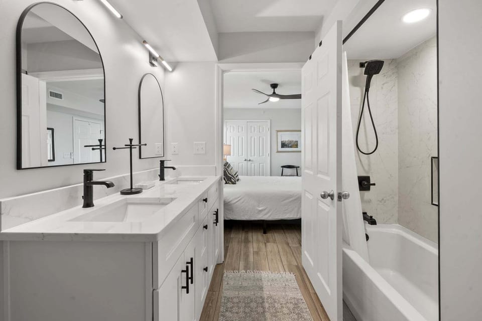Bathroom with a tub, a walk-in shower and a vanity for two at North Shore Villas 501, an Ocean Drive vacation rental