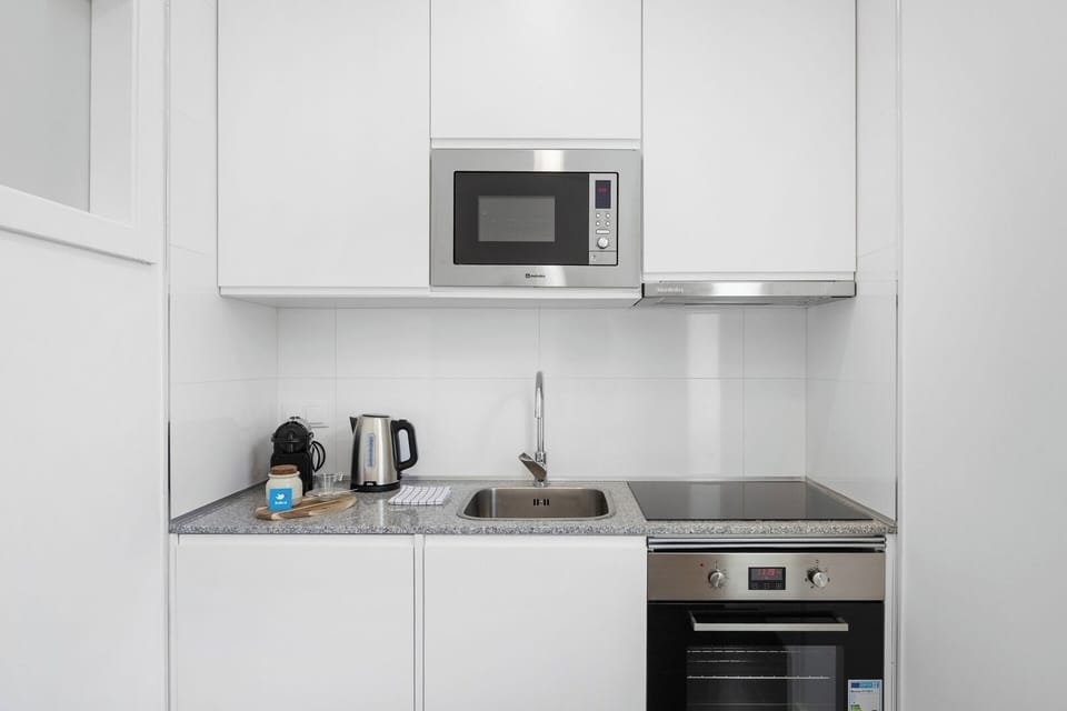 Equipped kitchenette with dining table.