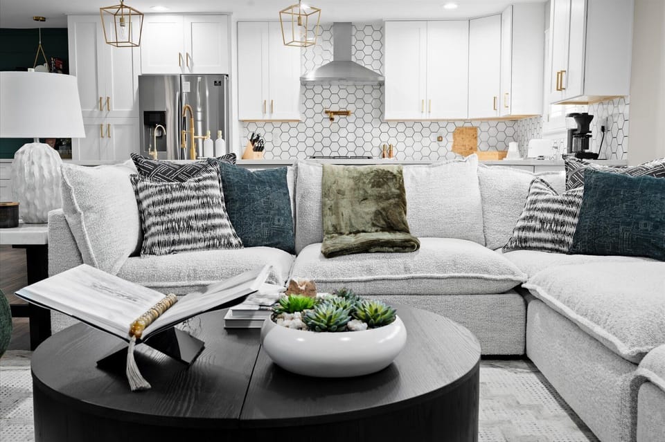 Relax in a stylish, open-concept living area where comfort meets design. Lounge on plush seating, enjoy easy conversation, and stay connected to the heart of the home with seamless flow into the kitchen and dining space.