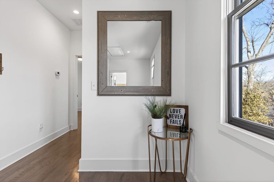 Hallway entry area with a large framed mirror and a decorative console table.