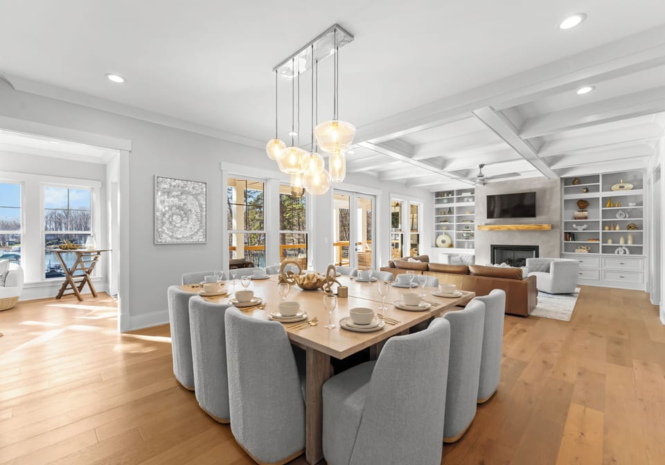 Open-concept dining and living room with access to the balcony and sunroom.