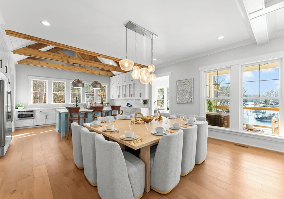 Dining and kitchen with modern appliances and a lake view.
