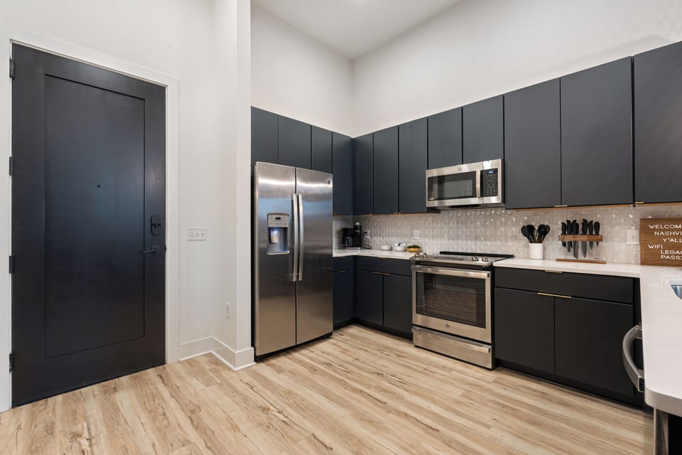 Fully equipped modern kitchen with stainless steel appliances, sleek cabinetry, and plenty of space to cook and gather.