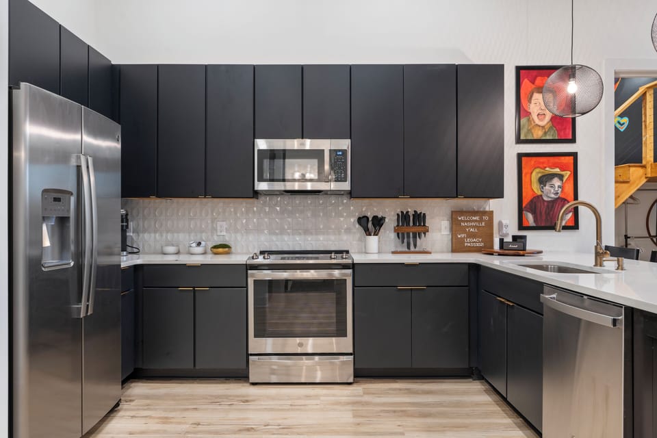Fully equipped modern kitchen with stainless steel appliances, sleek cabinetry, and plenty of space to cook and gather.