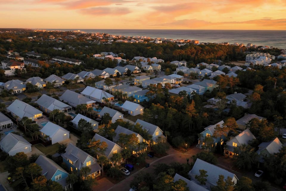 Aerial sunset view of the quiet coastal neighborhood and proximity to the beach.