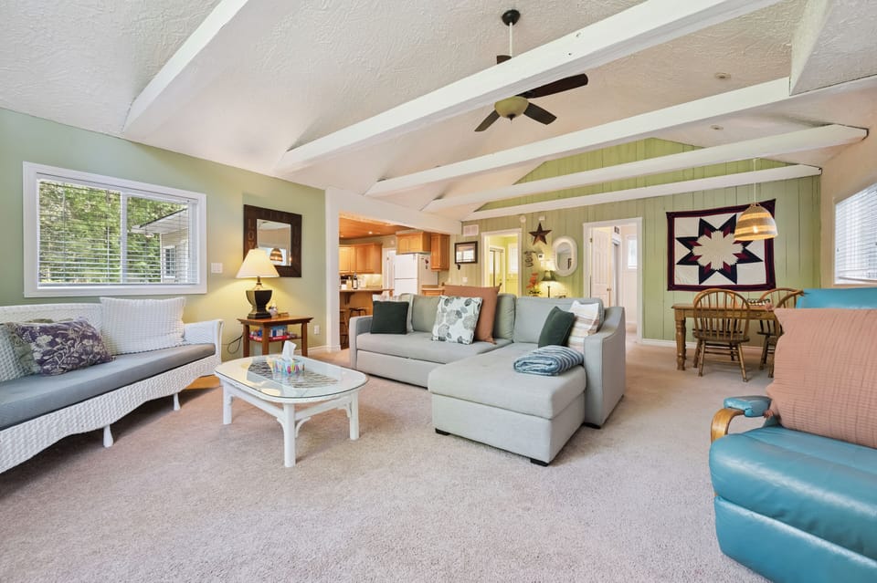 Bright, open-concept living space with vaulted ceilings and comfy seating for relaxing together.