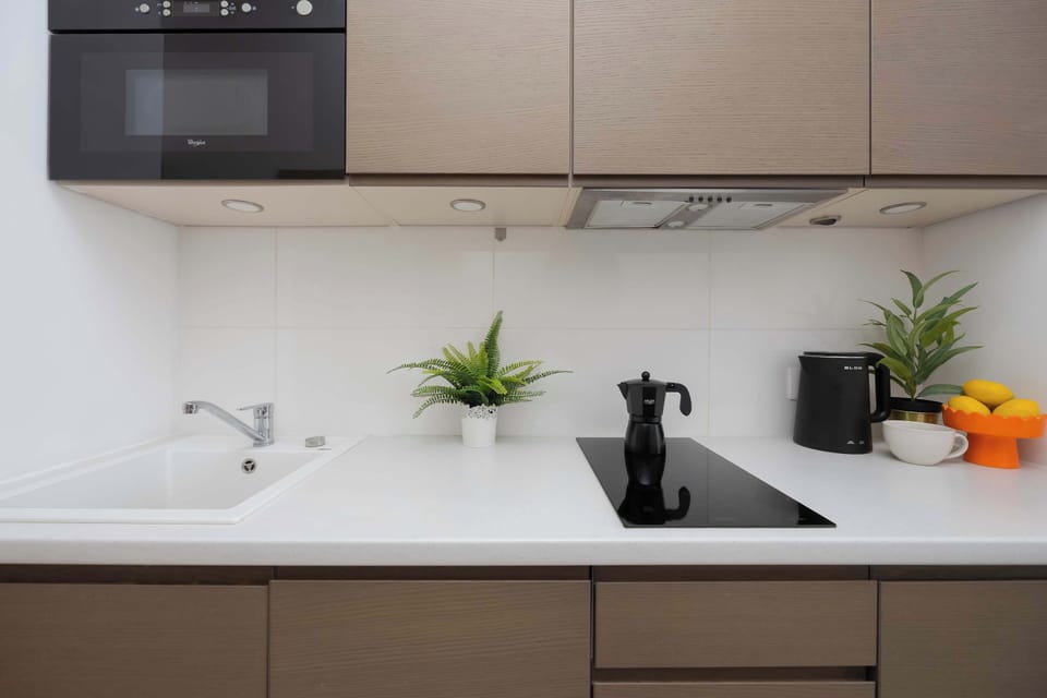 Fully equipped kitchenette with sink and microwave.