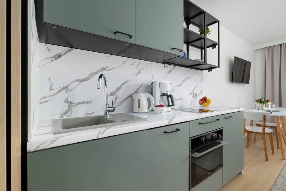 Fully equipped kitchenette with modern finish.