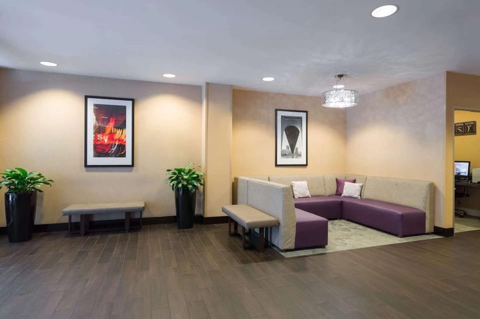 Lobby with purple seating area and framed wall art